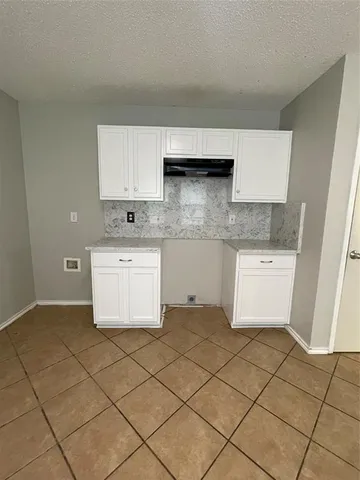a kitchen with stainless steel appliances a sink stove and cabinets
