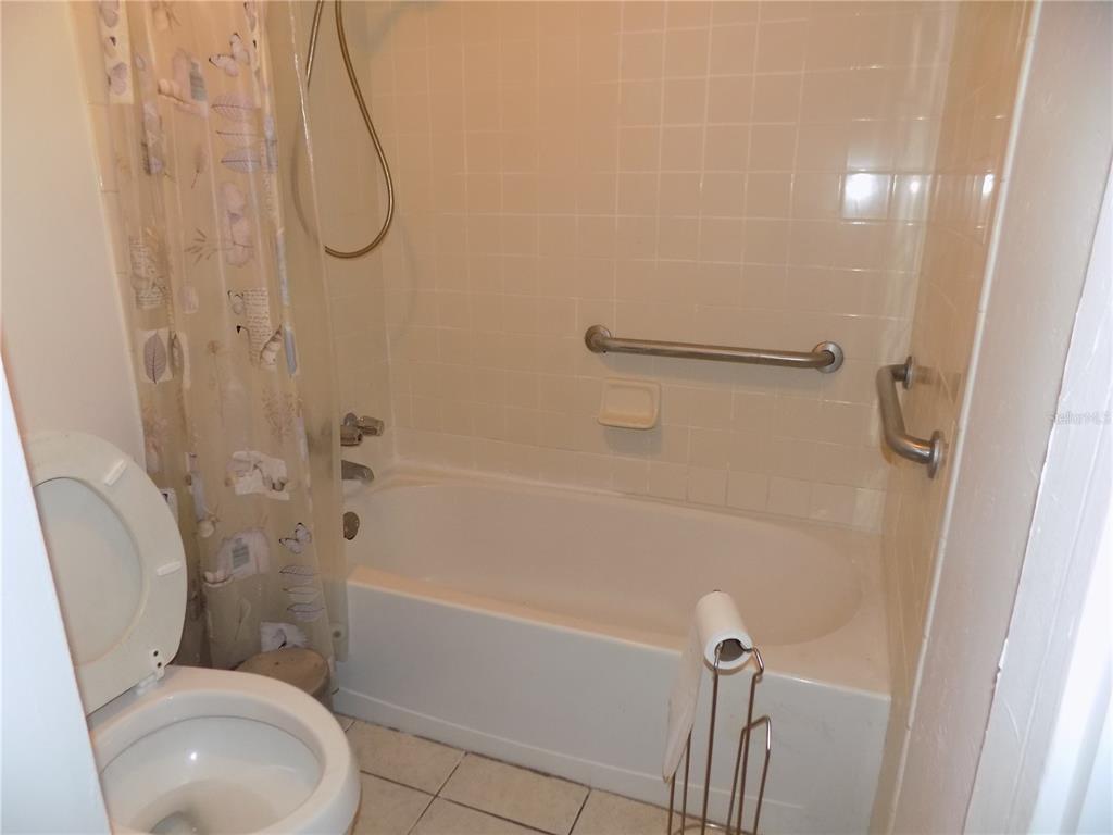 2811 Southwest Archer Road, Unit X 201 Gainesville, FL 32608 - Photo 17 of 27 a bathroom with a toilet and a shower