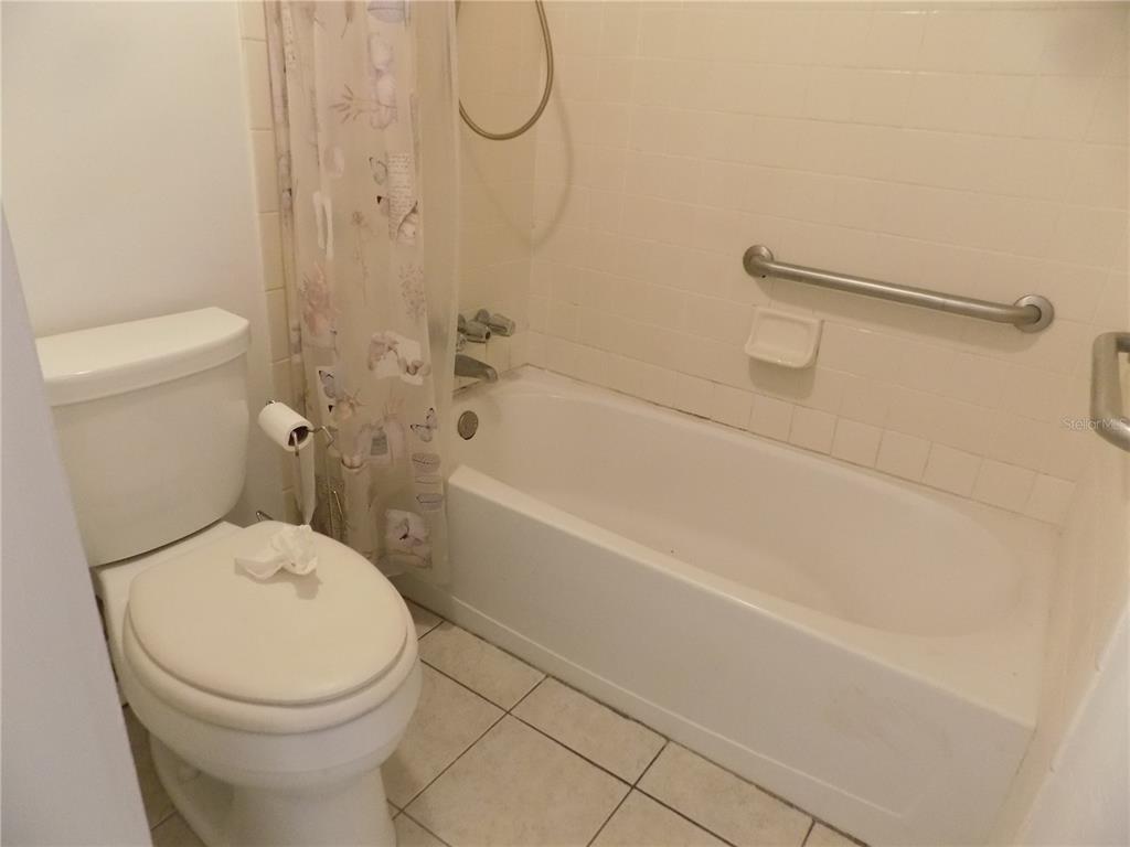 2811 Southwest Archer Road, Unit X 201 Gainesville, FL 32608 - Photo 20 of 27 a white toilet sitting next to a bath tub and a shower