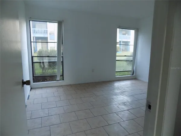 a view of an empty room with a window