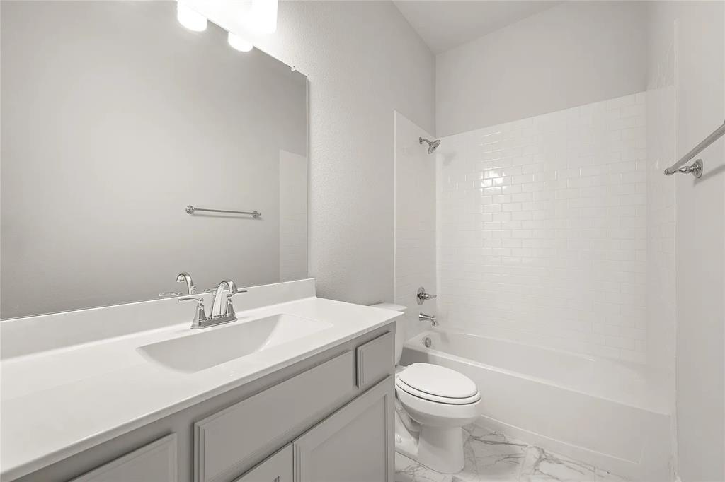 4021 Alpine Street Midlothian, TX 76065 - Photo 17 of 18 Bathroom featuring a single vanity with an integrated sink, white countertop, chrome faucet, and a large wall-mounted mirror