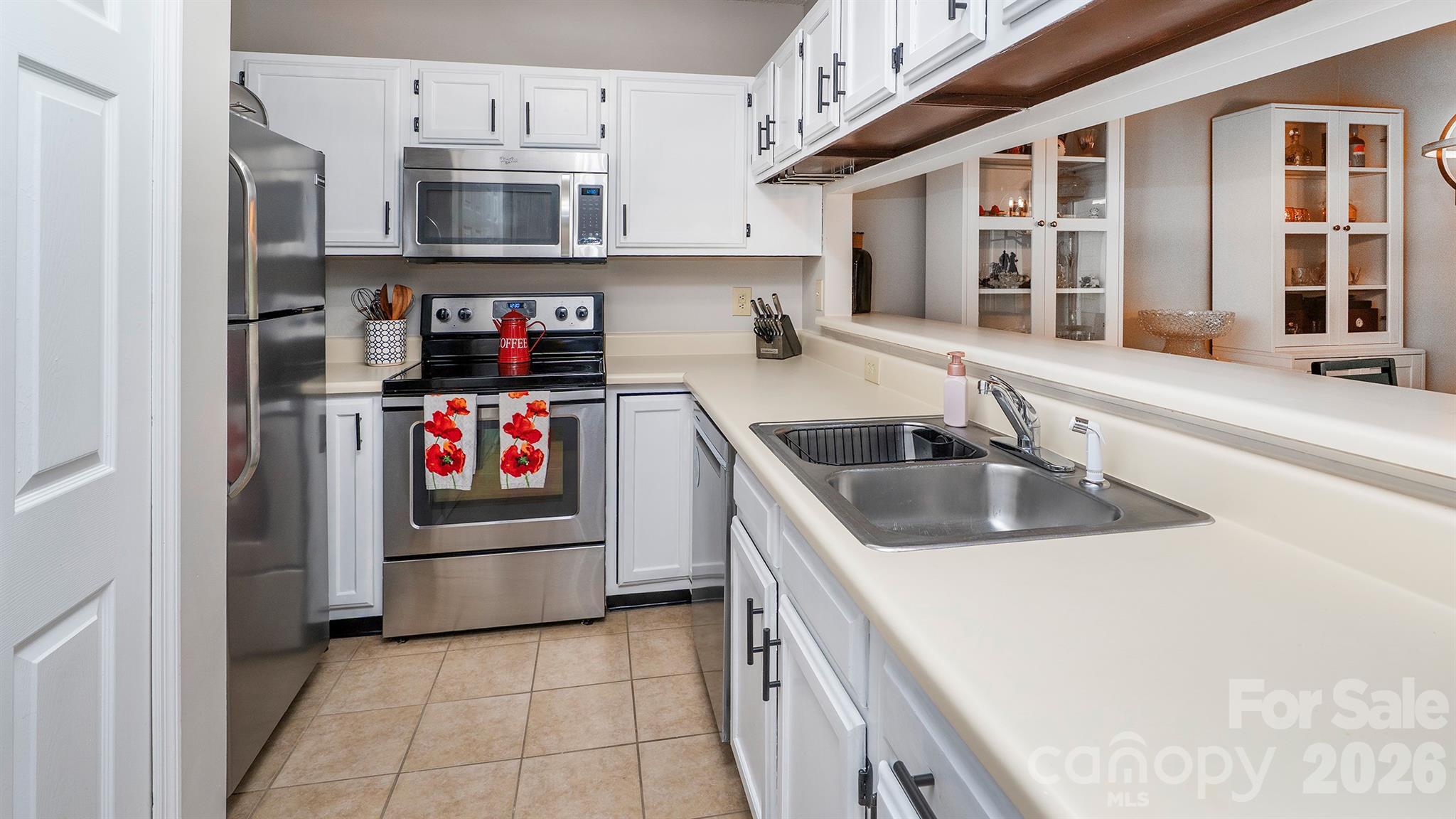 19823 Henderson Road, Unit C Cornelius, NC 28031 - Photo 5 of 23 a kitchen with stainless steel appliances granite countertop a sink and a refrigerator