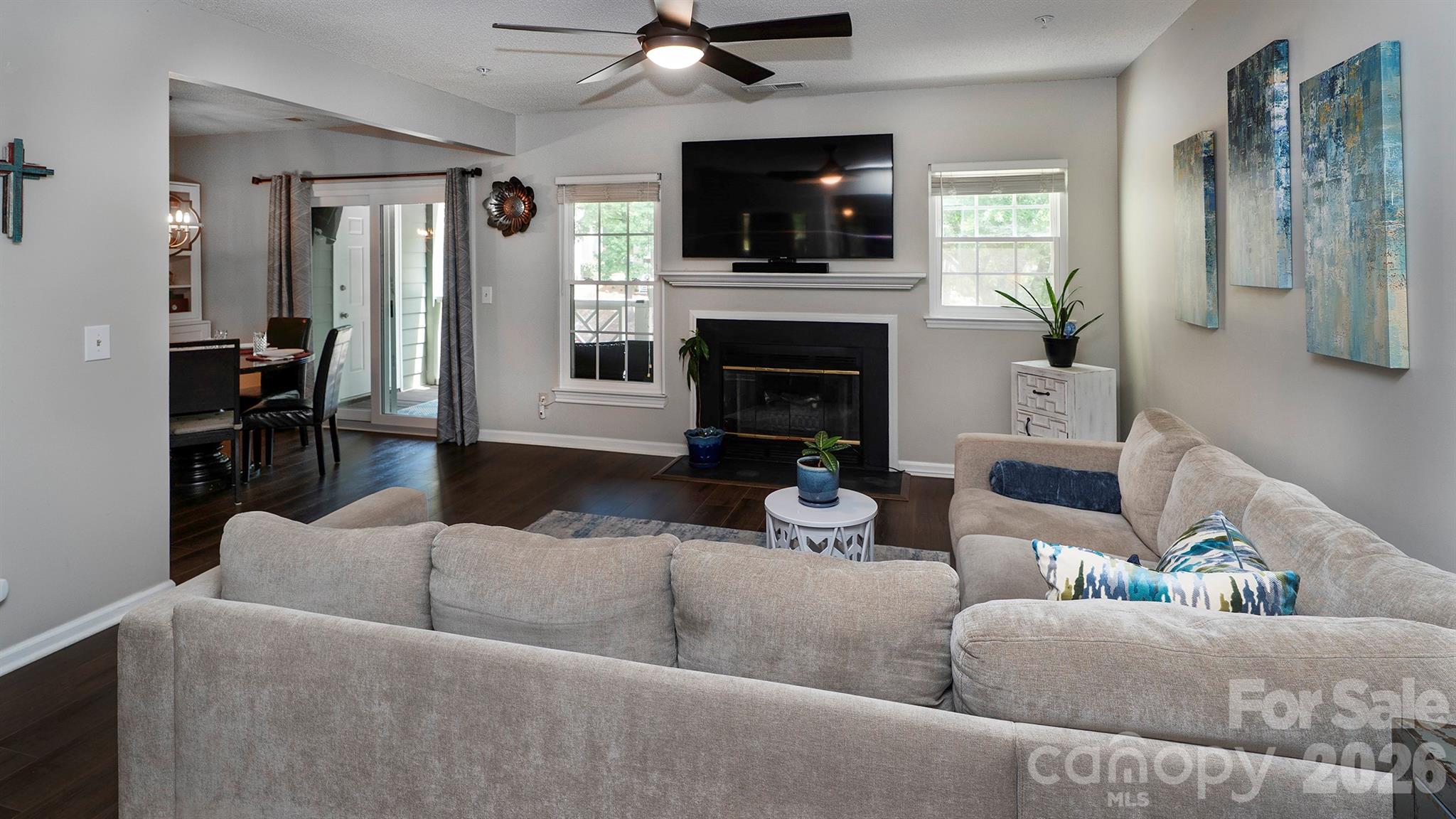 19823 Henderson Road, Unit C Cornelius, NC 28031 - Photo 6 of 23 a living room with furniture a flat screen tv and a fireplace