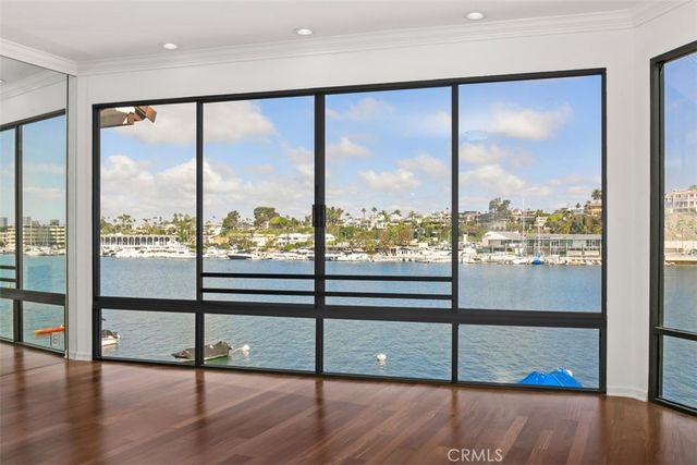 a view of a room with wooden floor and windows
