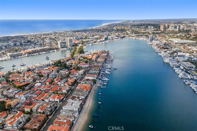 an empty room with wooden floor fireplace and windows