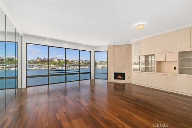 a kitchen with stainless steel appliances granite countertop a refrigerator a stove and a sink with wooden floor