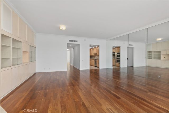 a kitchen with stainless steel appliances granite countertop a refrigerator a stove a sink and a microwave