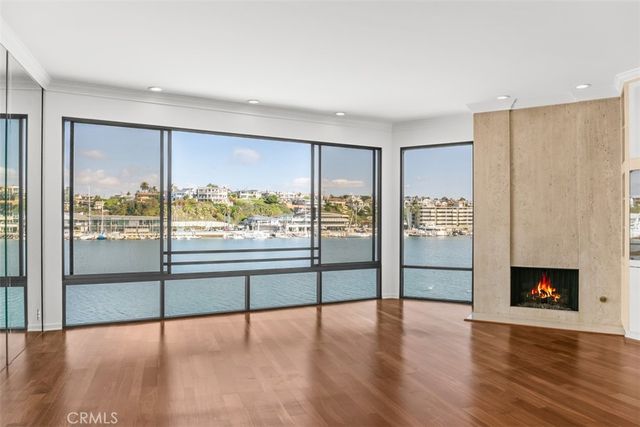 a kitchen with granite countertop a sink a refrigerator a stove top oven and cabinets