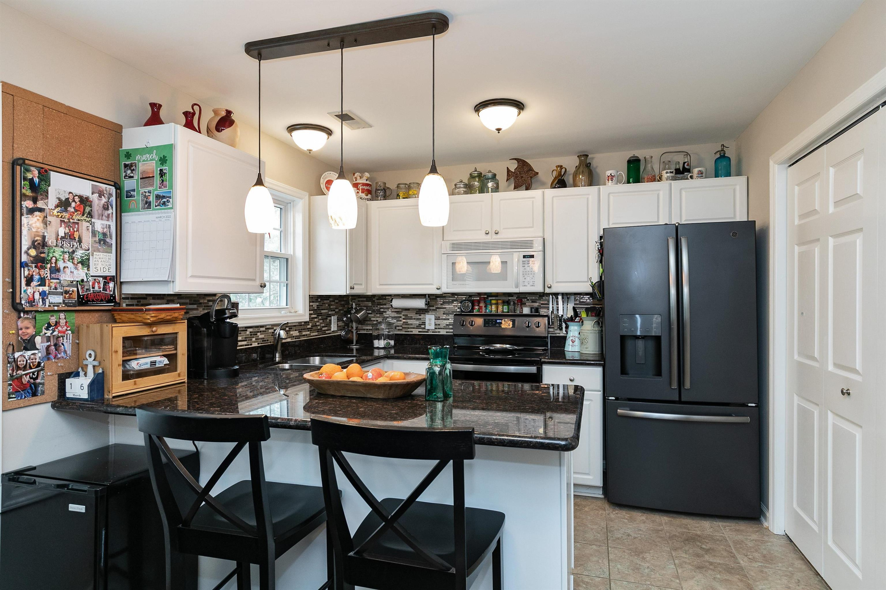 2213 Wellington Ridge Loop Cary, NC 27518 - Photo 7 of 29 Kitchen has updated counters, lighting, & back splash... Kitchen