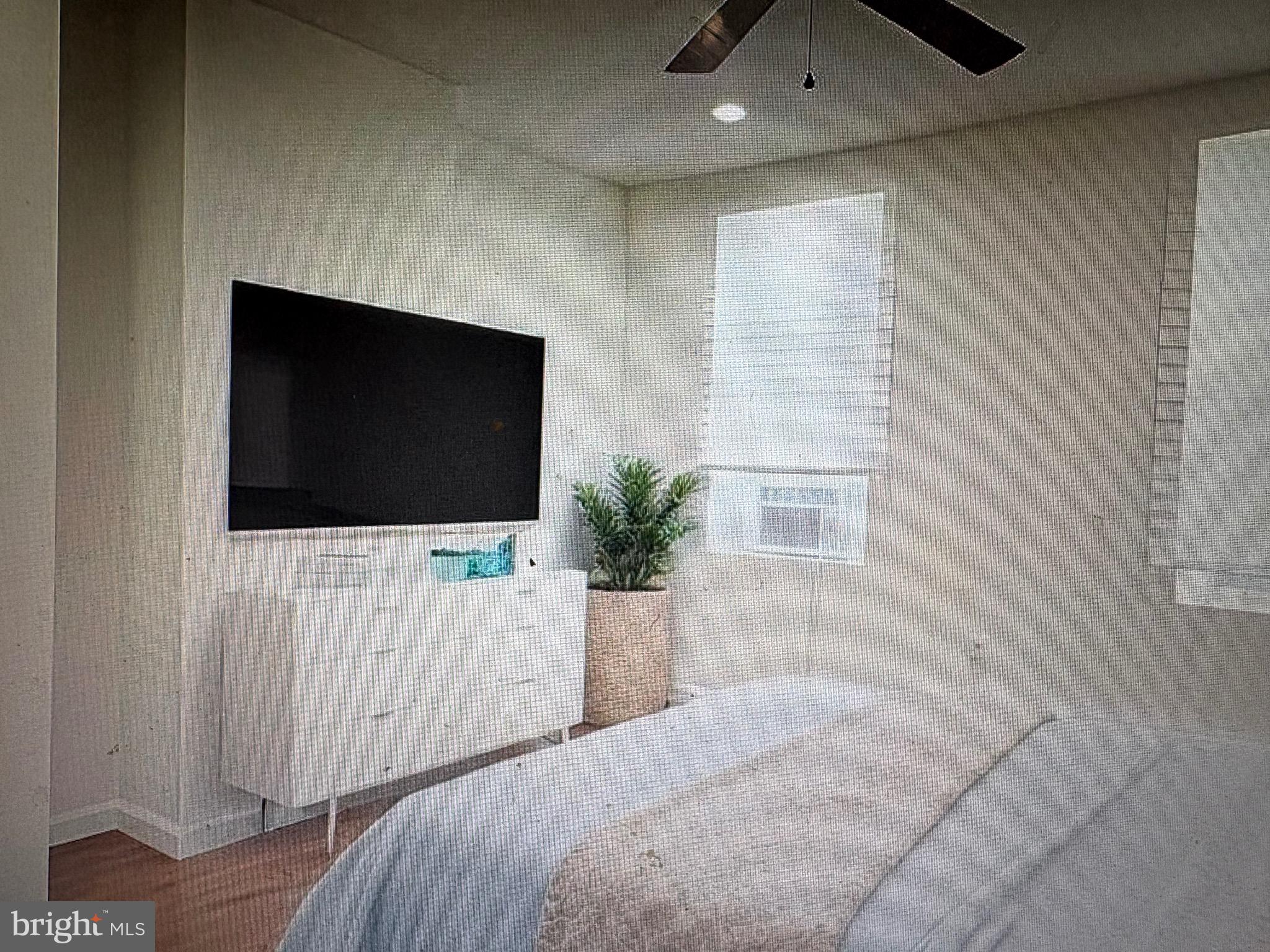 1929 North 9th Street Philadelphia, PA 19122 - Photo 18 of 21 a bedroom with a bed and a flat screen tv