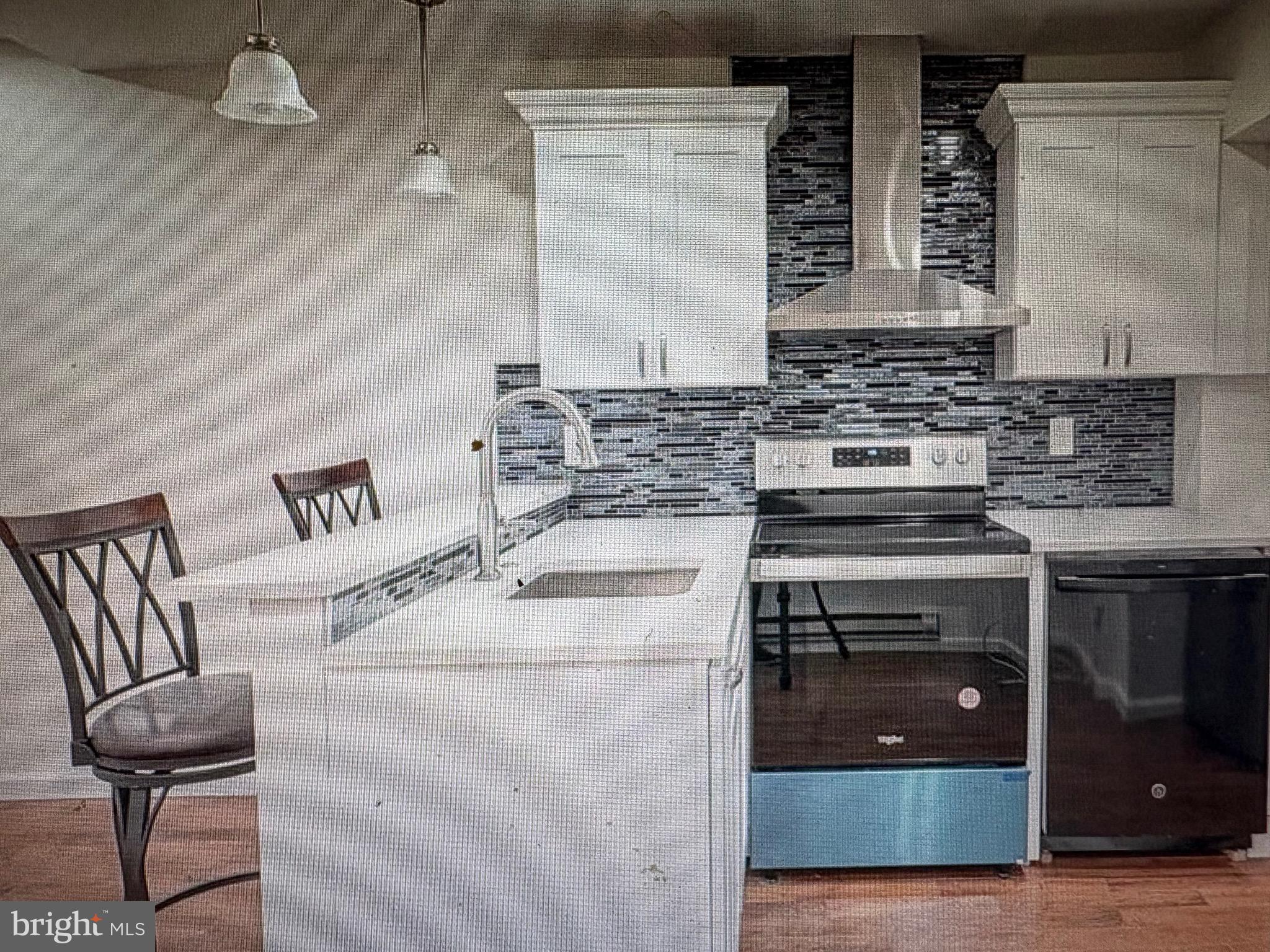 1929 North 9th Street Philadelphia, PA 19122 - Photo 19 of 21 a kitchen with a stove and a microwave