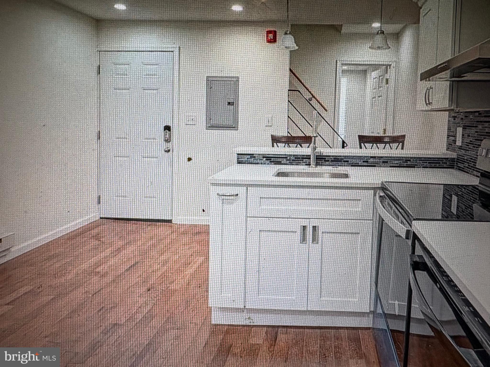 1929 North 9th Street Philadelphia, PA 19122 - Photo 20 of 21 a kitchen with white cabinets and sink