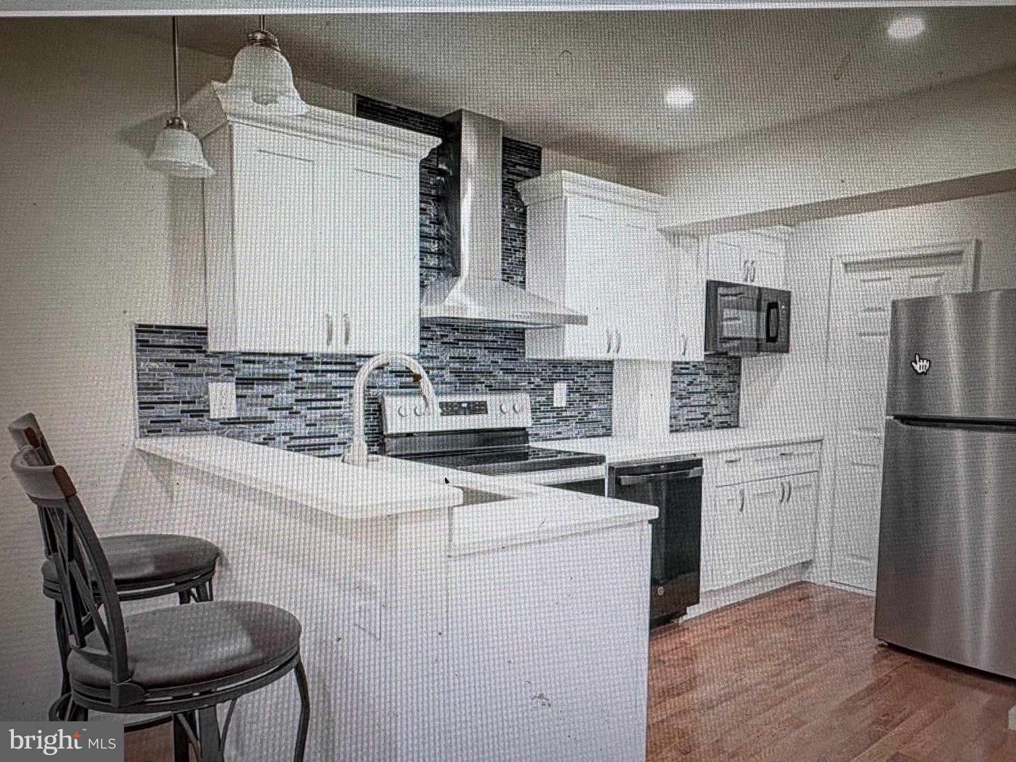 1929 North 9th Street Philadelphia, PA 19122 - Photo 2 of 21 a kitchen with stainless steel appliances a sink stove and refrigerator