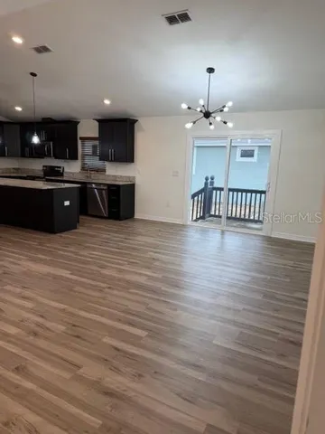 a view of kitchen with wooden floor and window