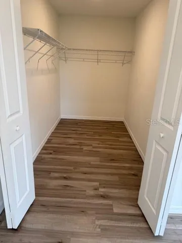 a view of a room with wooden floor