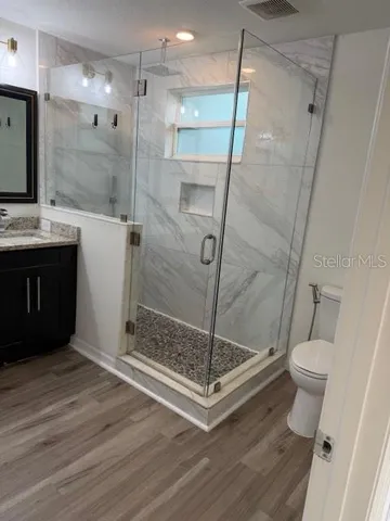 a bathroom with a shower toilet and sink