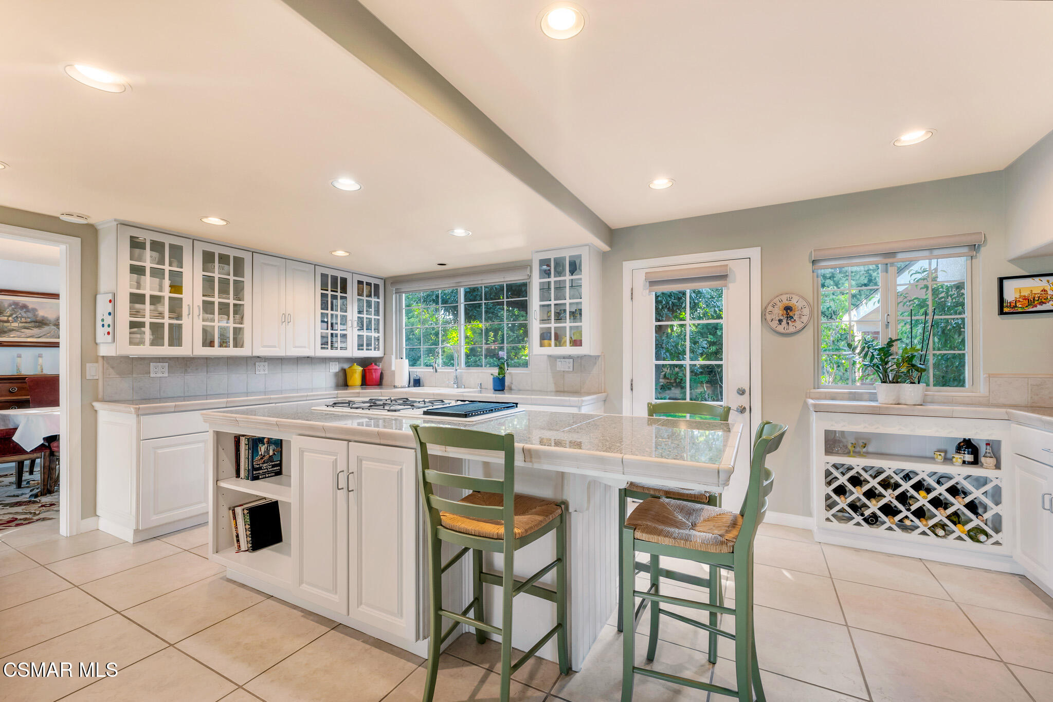 3037 Divernon Avenue Simi Valley, CA 93063 - Photo 11 of 44 a kitchen with a sink and chairs