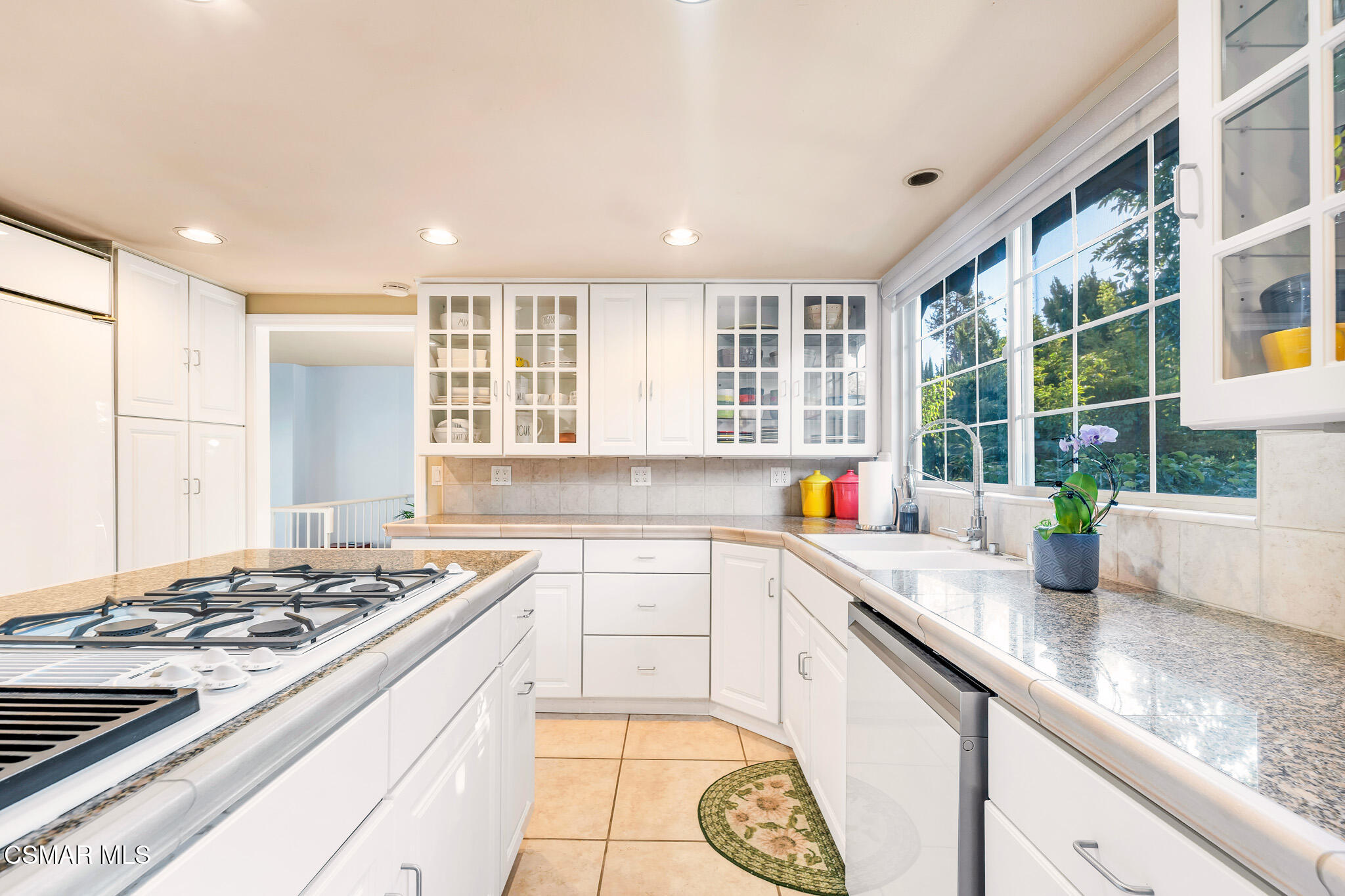 3037 Divernon Avenue Simi Valley, CA 93063 - Photo 13 of 44 a kitchen with sink stove and cabinets