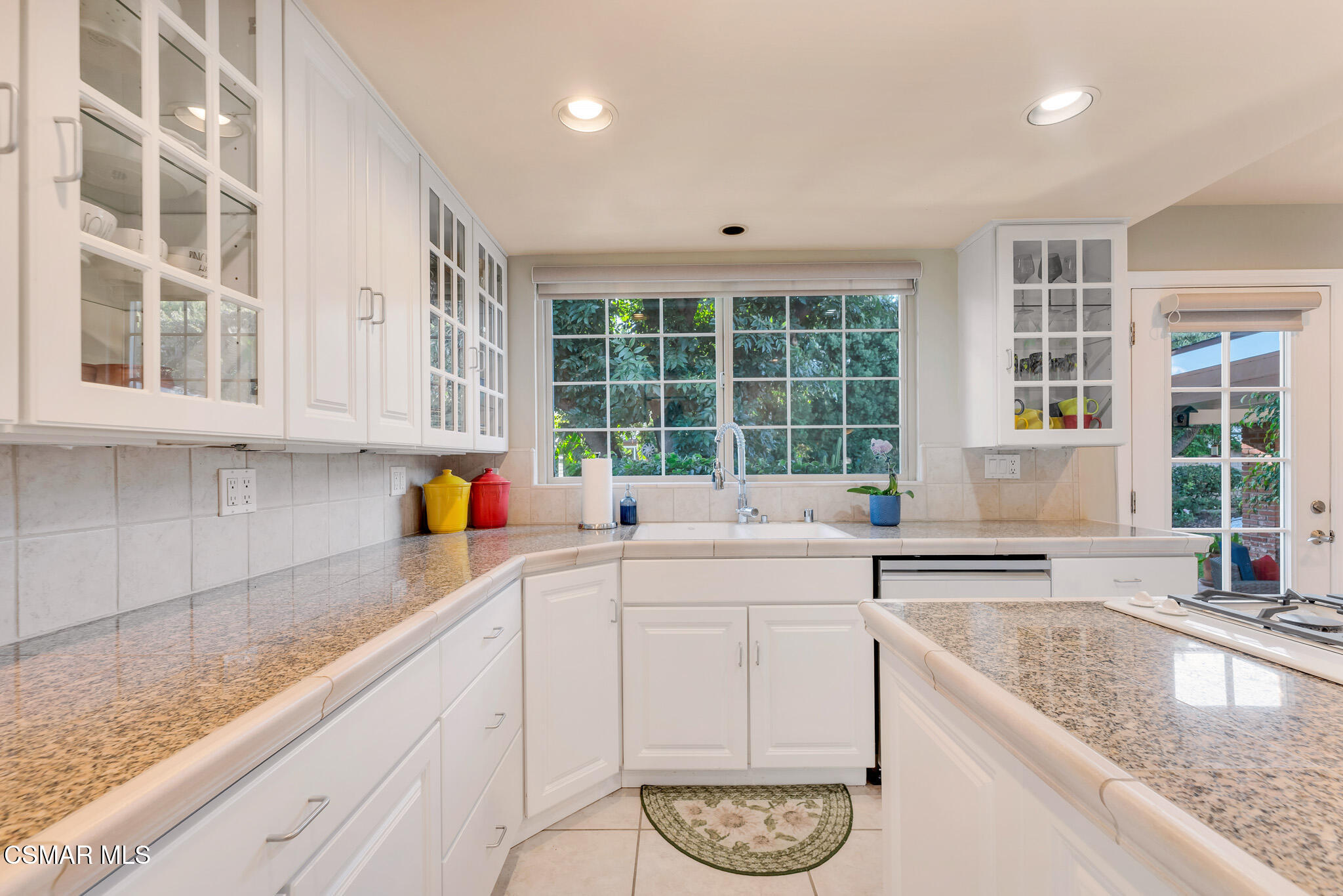 3037 Divernon Avenue Simi Valley, CA 93063 - Photo 10 of 44 a kitchen with stainless steel appliances granite countertop a sink and a white cabinets