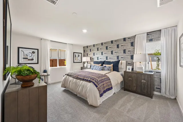 a bedroom with a bed and potted plant