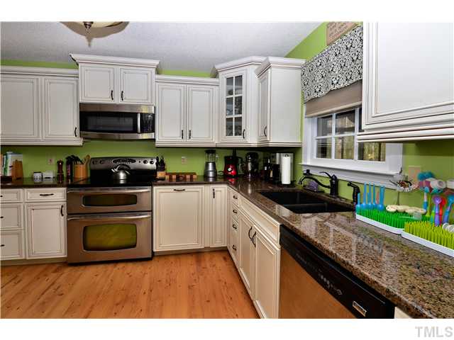 4308 Holly Run Road Apex, NC 27539 - Photo 9 of 18 LOADS OF CABINETS AND SPACE TO PREPARE FOOD ON THE GRANITE COUNTERTOPS IN THIS TOTALLY NEW KITCHEN AND CHECK OUT THE DOUBLE OVEN, TOO.