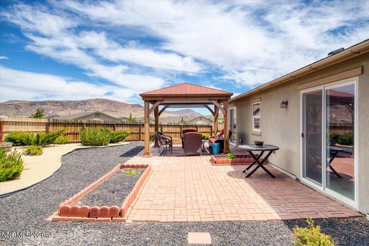 104 Bethpage Road Dayton, NV 89403 - Photo 40 of 65 a view of a patio with dining table and chairs with a barbeque
