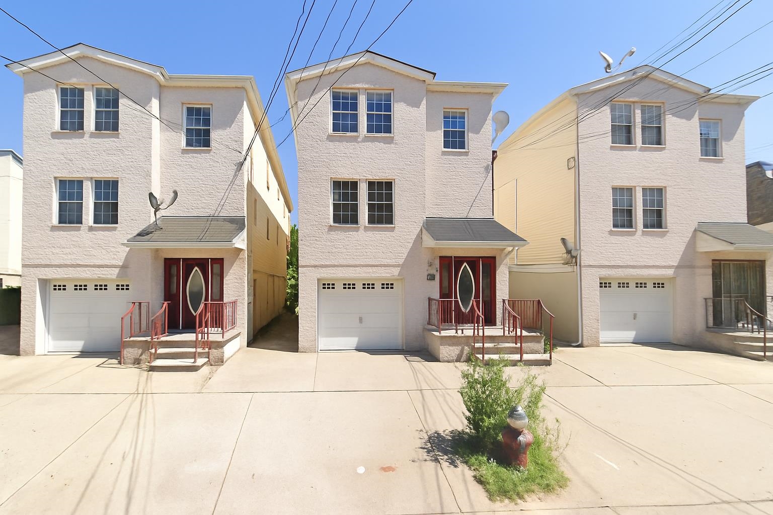 a view of a white house with large windows