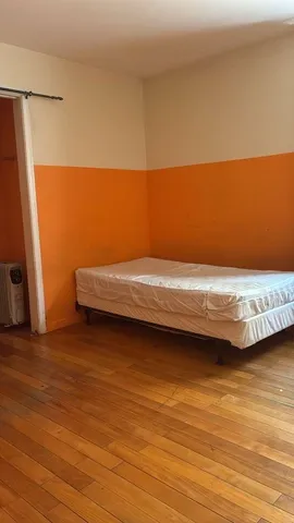 a view of a room with wooden floor and chair