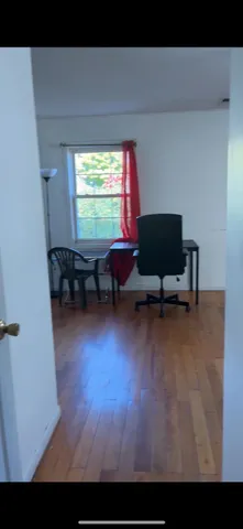 a living room with furniture window and wooden floor