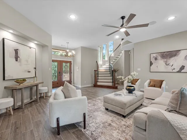 a living room with furniture and wooden floor
