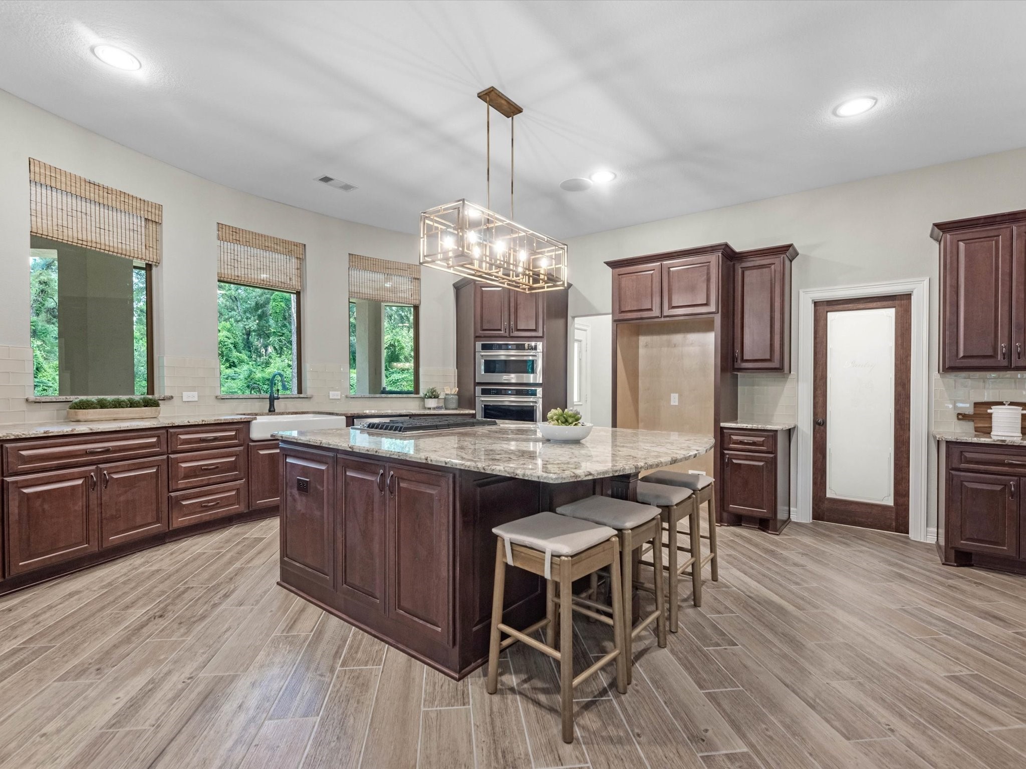 19332 Chateau Ridge Court Tomball, TX 77377 - Photo 11 of 50 a kitchen with stainless steel appliances granite countertop wooden floors and stove