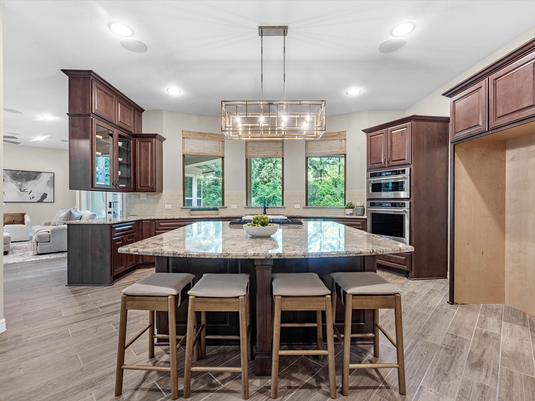 19332 Chateau Ridge Court Tomball, TX 77377 - Photo 12 of 50 a kitchen with stainless steel appliances granite countertop a kitchen island hardwood floor and a view of living room