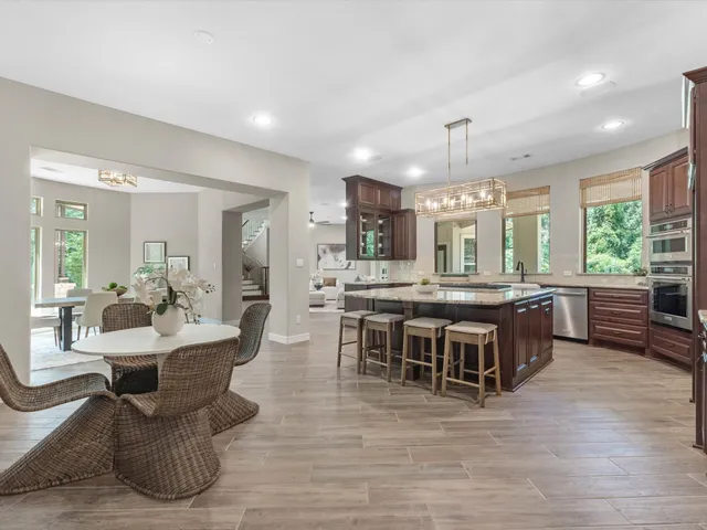 a large kitchen with a table and chairs in it