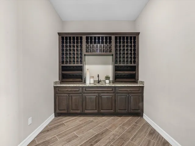a view of kitchen with granite countertop cabinets and sink