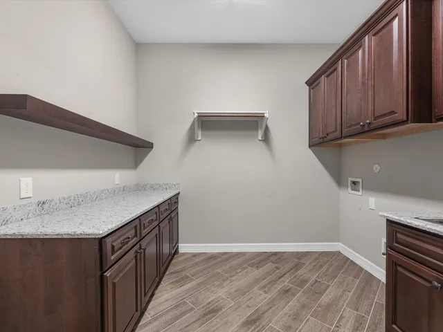a kitchen with granite countertop a sink and a stove