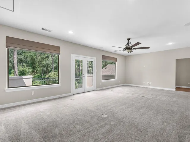 a view of a livingroom with a ceiling fan and window