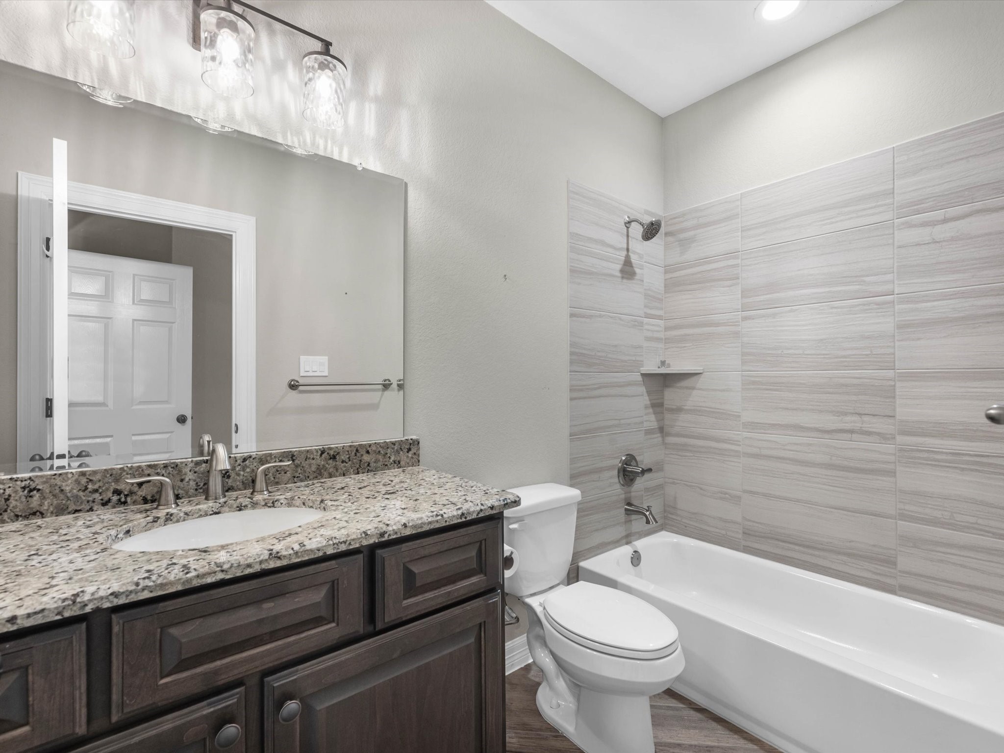 19332 Chateau Ridge Court Tomball, TX 77377 - Photo 38 of 50 a bathroom with a granite countertop toilet a sink and a bathtub