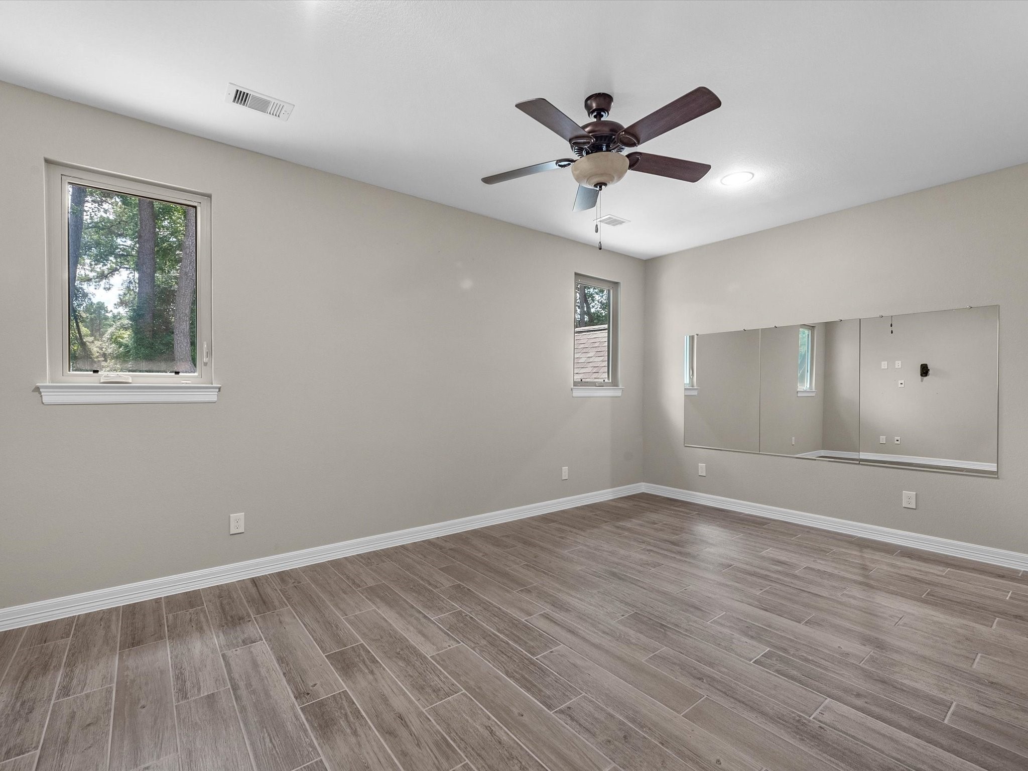 19332 Chateau Ridge Court Tomball, TX 77377 - Photo 39 of 50 a view of an empty room with wooden floor and a window