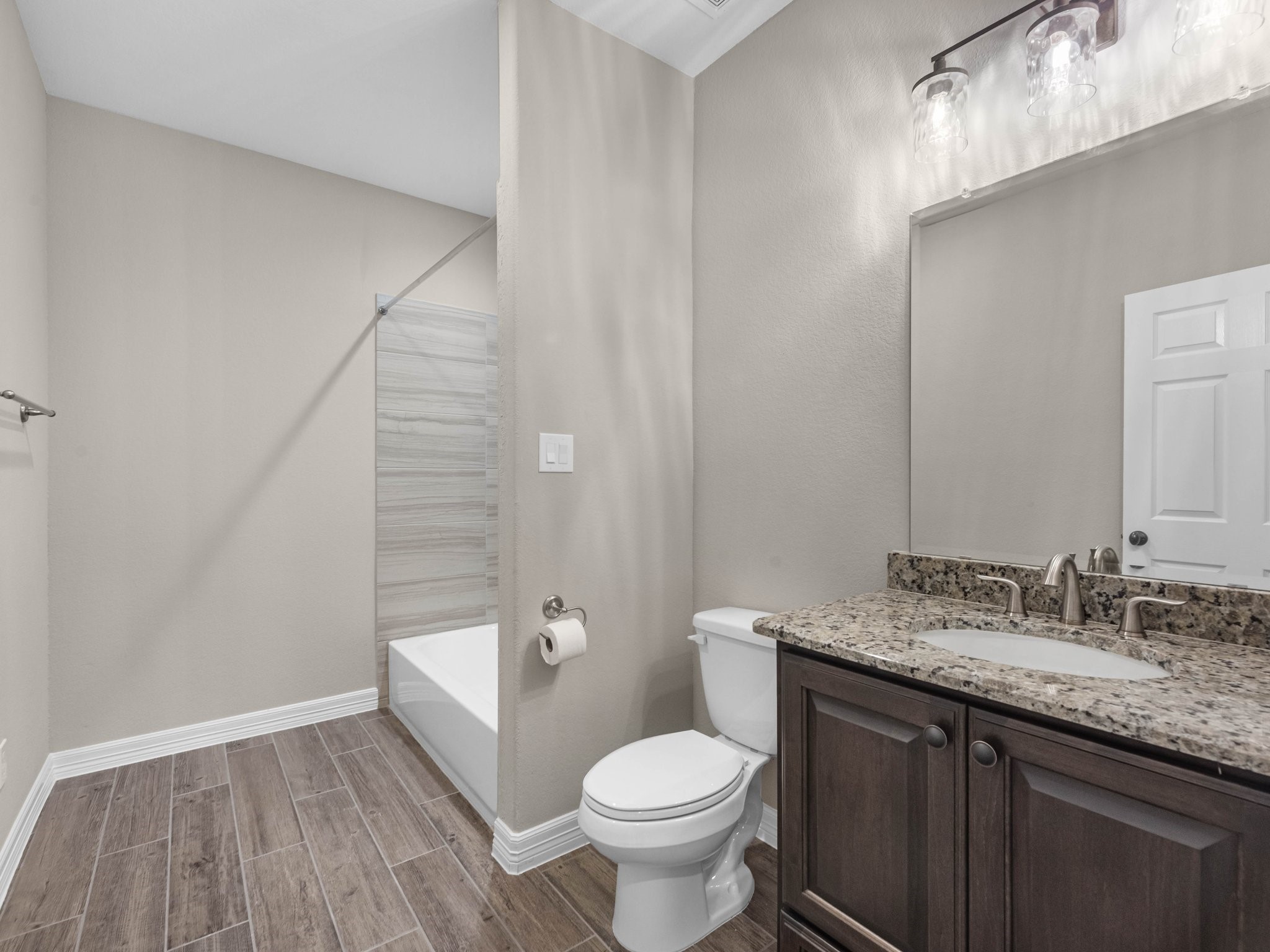19332 Chateau Ridge Court Tomball, TX 77377 - Photo 40 of 50 a bathroom with a granite countertop toilet sink and mirror