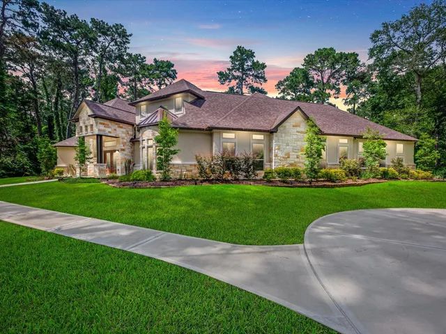 a view of a big house with a big yard and potted plants