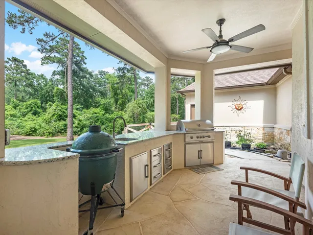 a kitchen with a stove a sink and wooden cabinets