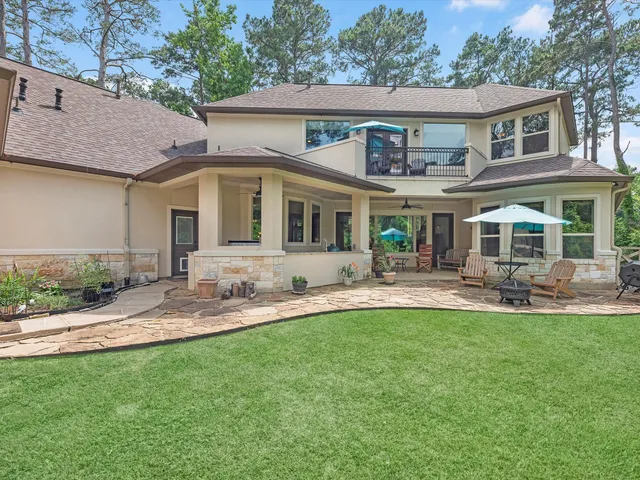 a front view of a house with a yard and patio