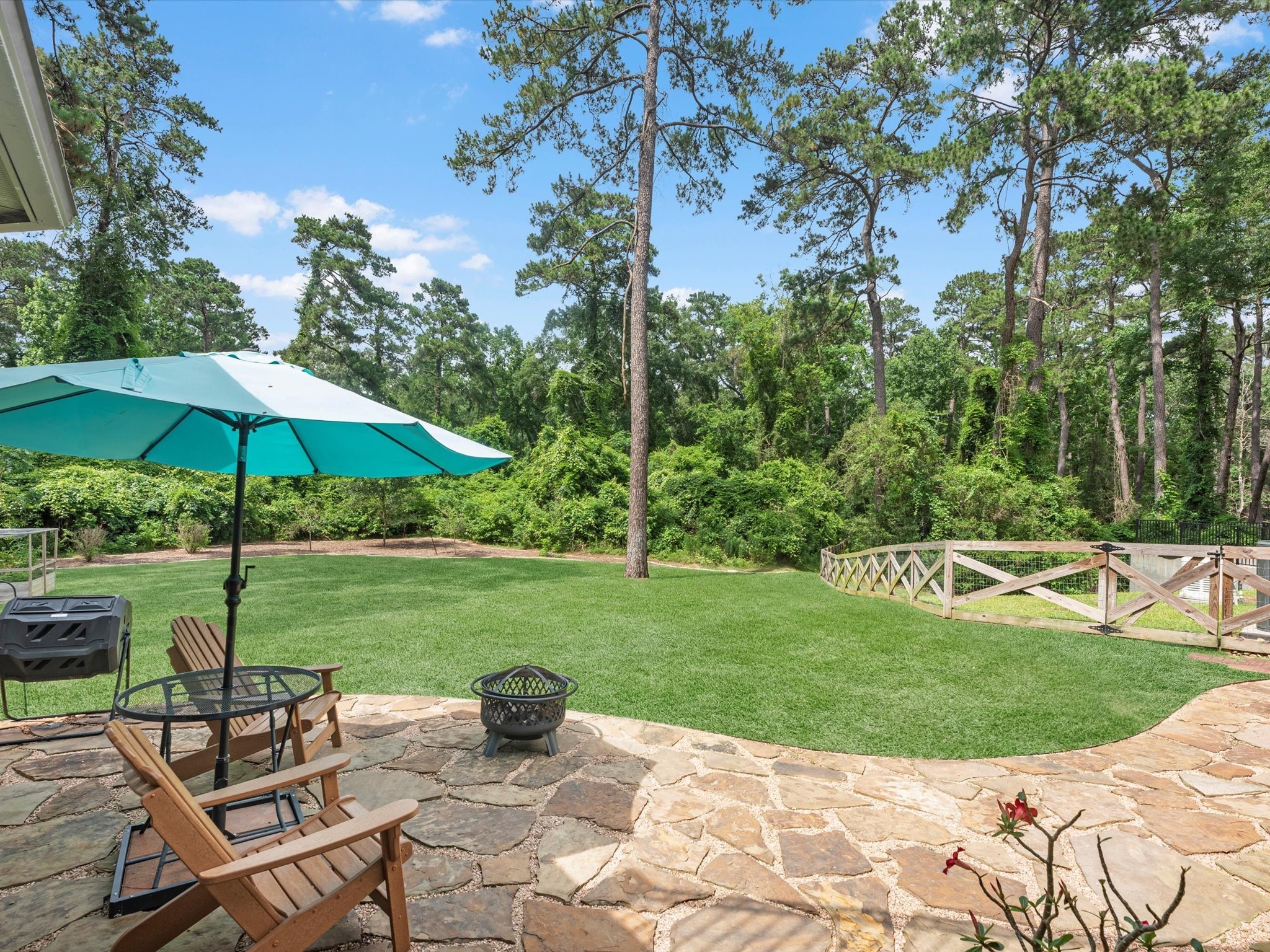 19332 Chateau Ridge Court Tomball, TX 77377 - Photo 45 of 50 a view of a table and chairs under an umbrella