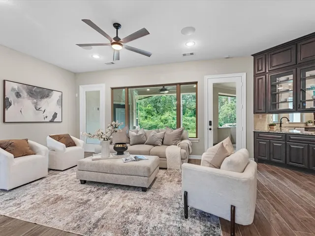 a living room with furniture and floor to ceiling windows