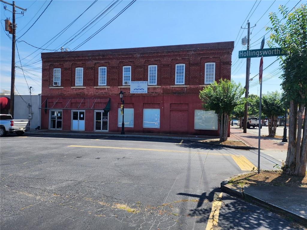 6958 Main Street Lithonia, GA 30058 - Photo 2 of 55 a view of a brick building with many windows