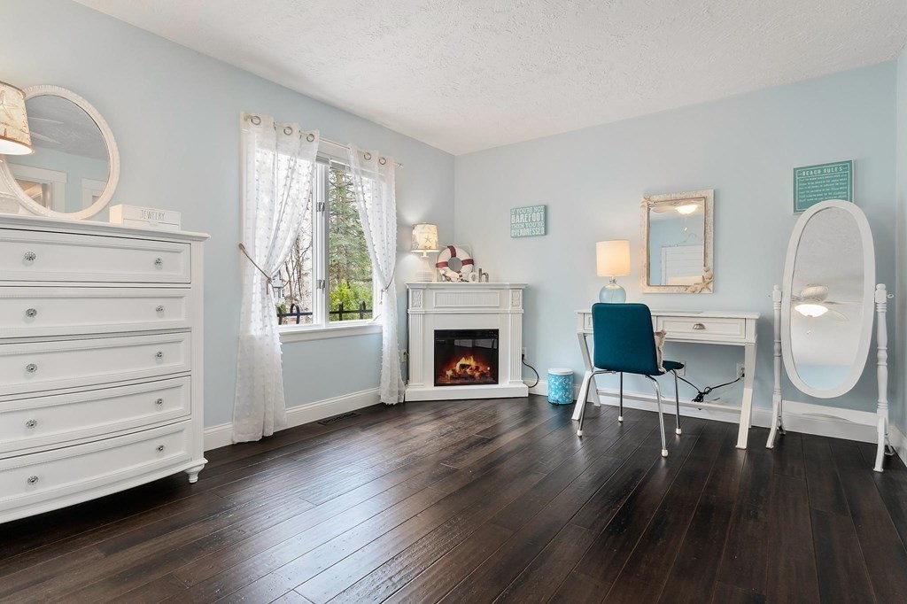 18 Durham Drive Lynnfield, MA 01940 - Photo 15 of 35 a living room with furniture a fireplace and a large window