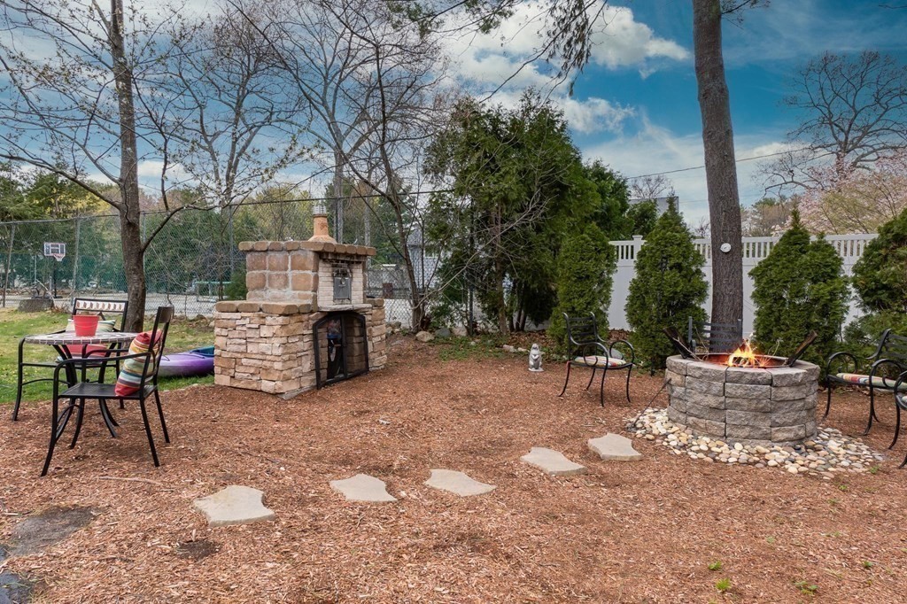 18 Durham Drive Lynnfield, MA 01940 - Photo 30 of 35 a view of a chairs and table in a backyard