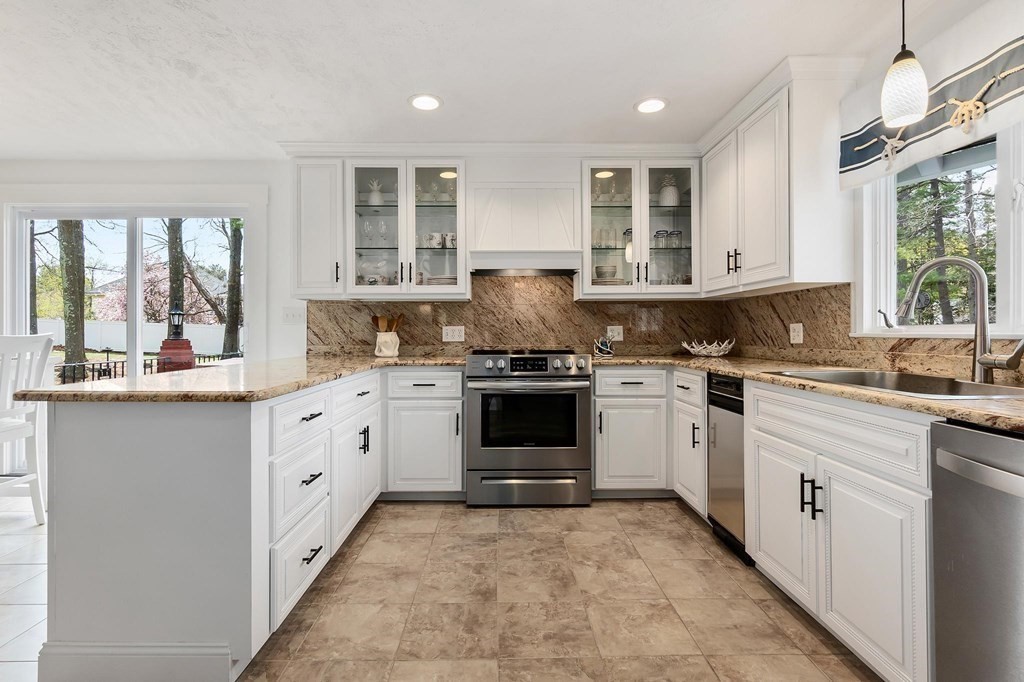 18 Durham Drive Lynnfield, MA 01940 - Photo 3 of 35 a kitchen with granite countertop a stove sink and cabinets