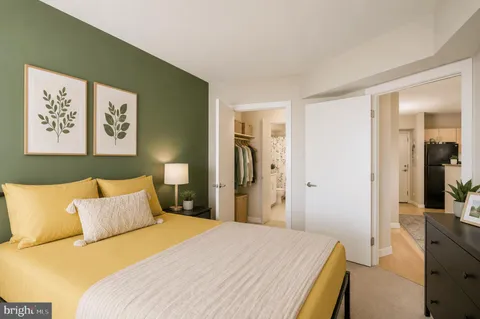 a bedroom with a bed and glass door