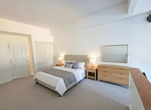 a bedroom with bed and window